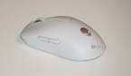The white Alienware Pro Gaming Mouse on a white desk.