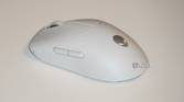 The white Alienware Pro Gaming Mouse on a white desk.