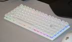 The Alienware Pro wireless keyboard on a desk with RGB lighting.