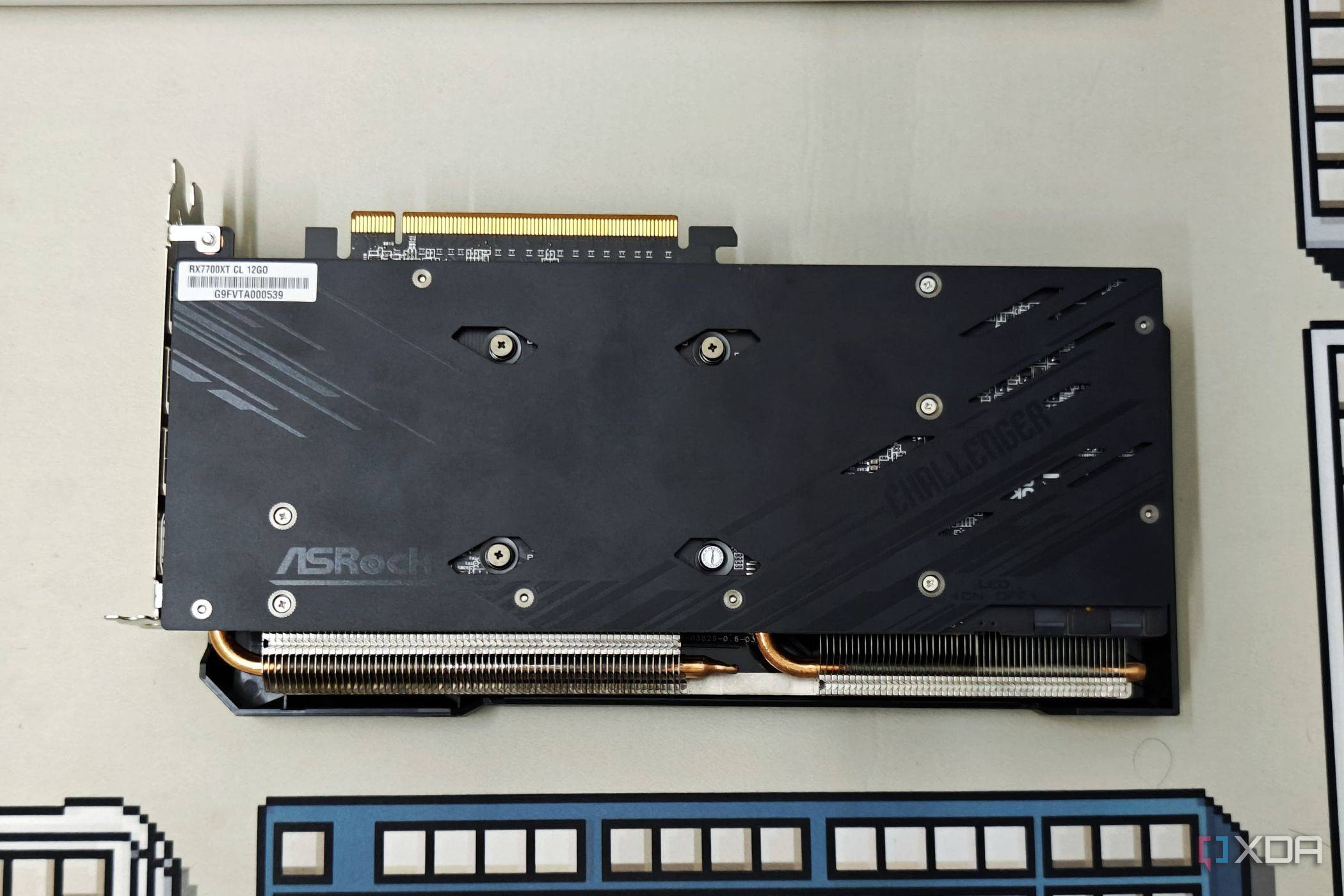 An image showing the backplate of the ASRock Challenger 7700XT GPU.
