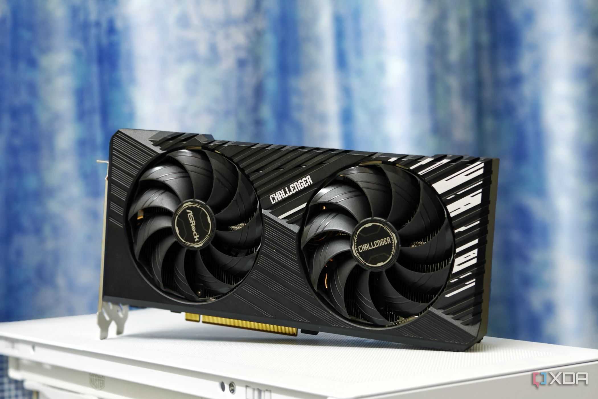 An image showing the ASRock Challenger RX 7700 XT 12G OC GPU kept on a white-colored PC case.