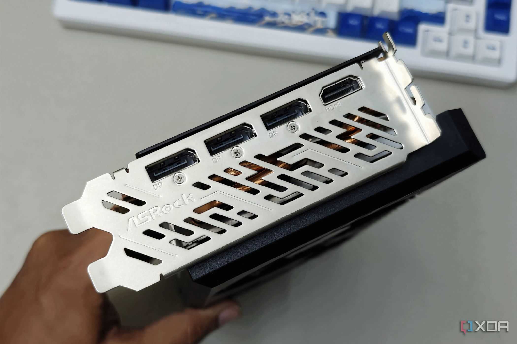 An image showing the IO shroud and ports of the ASRock RX 7700 XT GPU.
