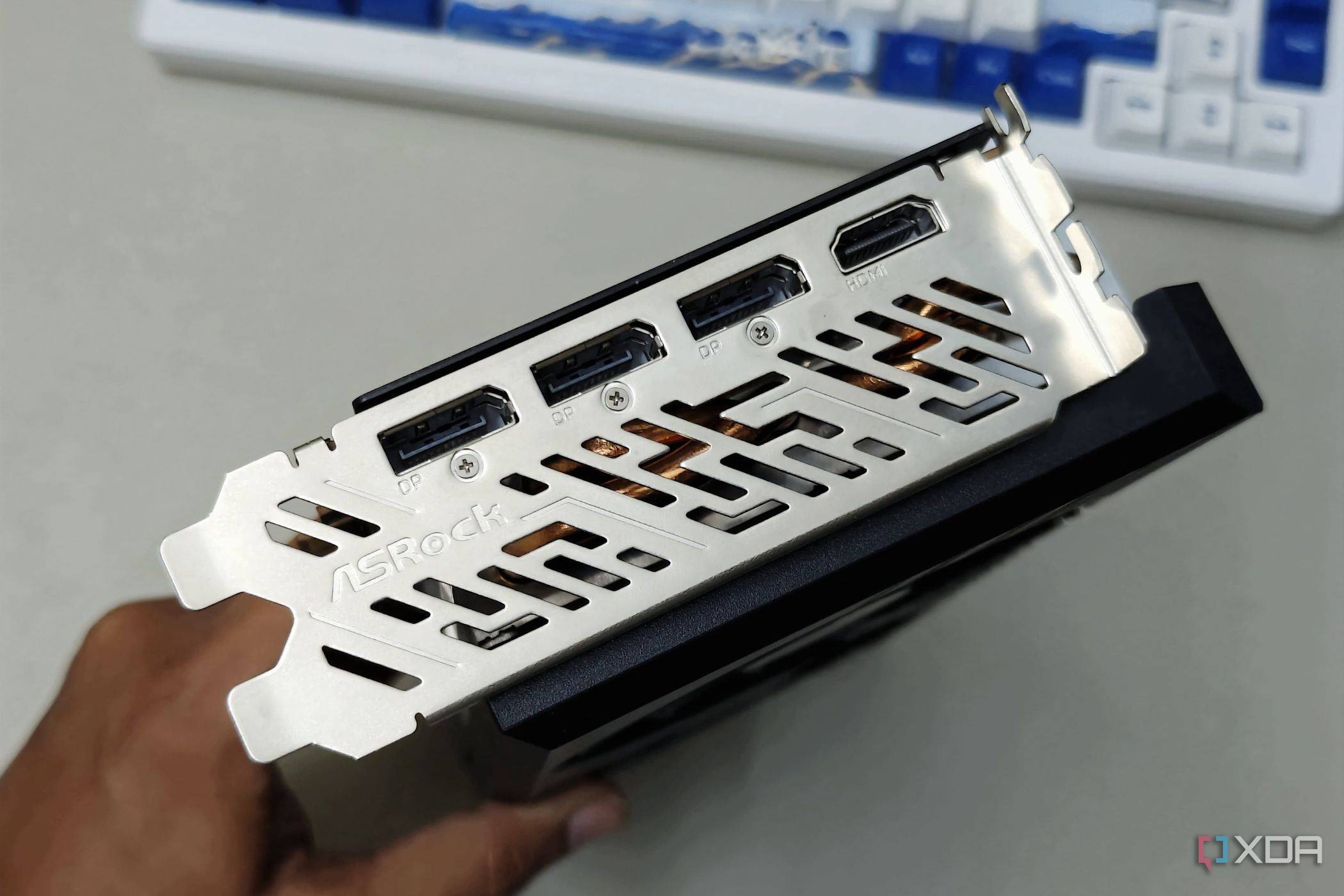 An image showing the IO shroud and ports of the ASRock RX 7700 XT GPU.