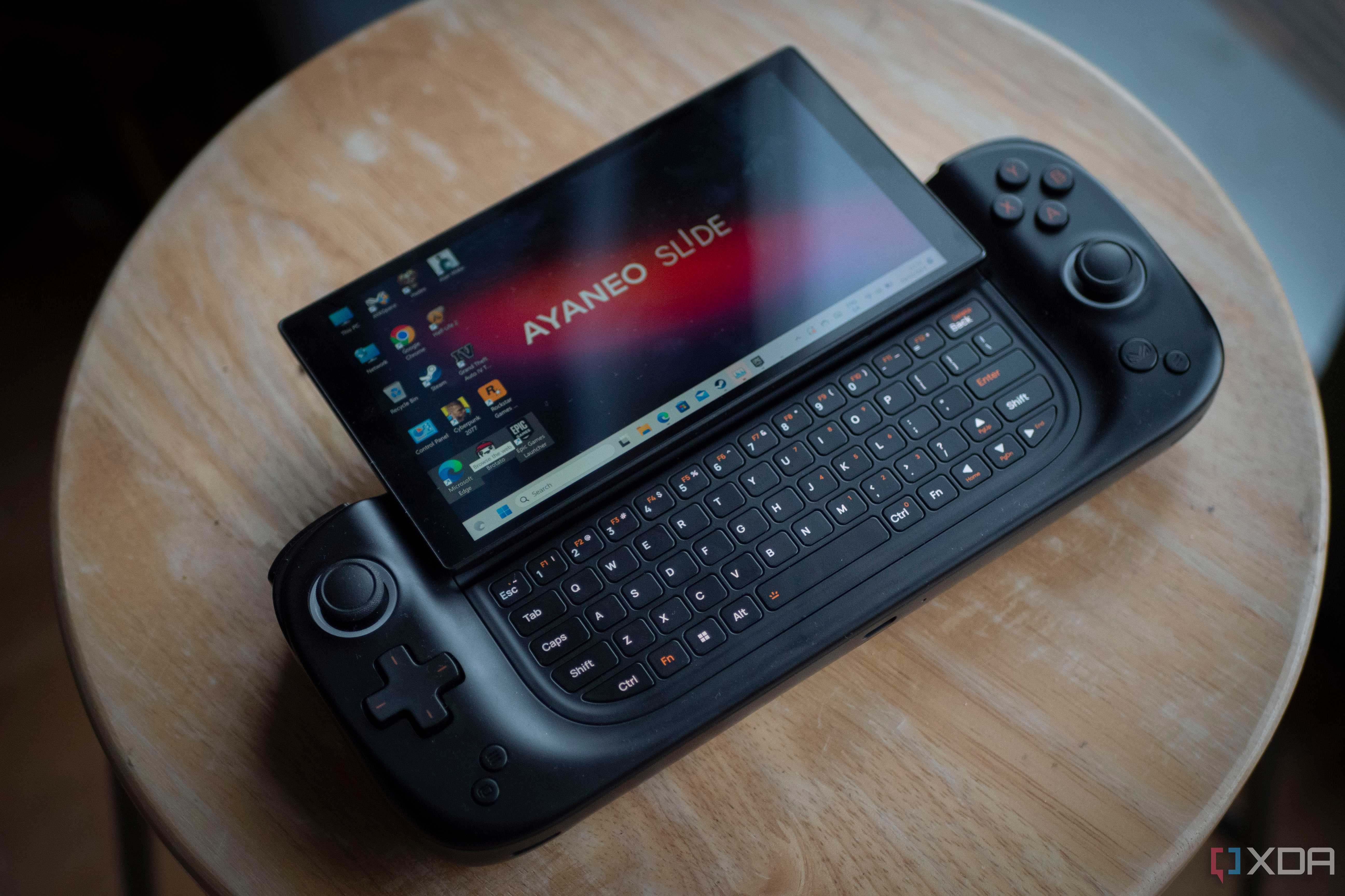 Ayaneo Slide on a table showing keyboard and Windows desktop