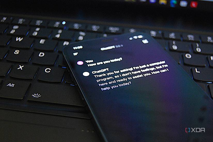 ChatGPT on an iPhone with laptop in the background