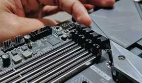 An image showing a person undoing the latches securing the ram modules on the slot.
