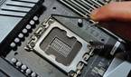 An image showing a person holding the metal level located next to the CPU socket.