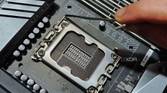 An image showing a person holding the metal level located next to the CPU socket.