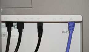 Ethernet and USB cables coming out of the back of a Dell UltraSharp monitor.