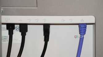 Ethernet and USB cables coming out of the back of a Dell UltraSharp monitor.