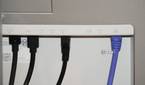 Ethernet and USB cables coming out of the back of a Dell UltraSharp monitor.