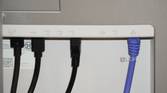 Ethernet and USB cables coming out of the back of a Dell UltraSharp monitor.