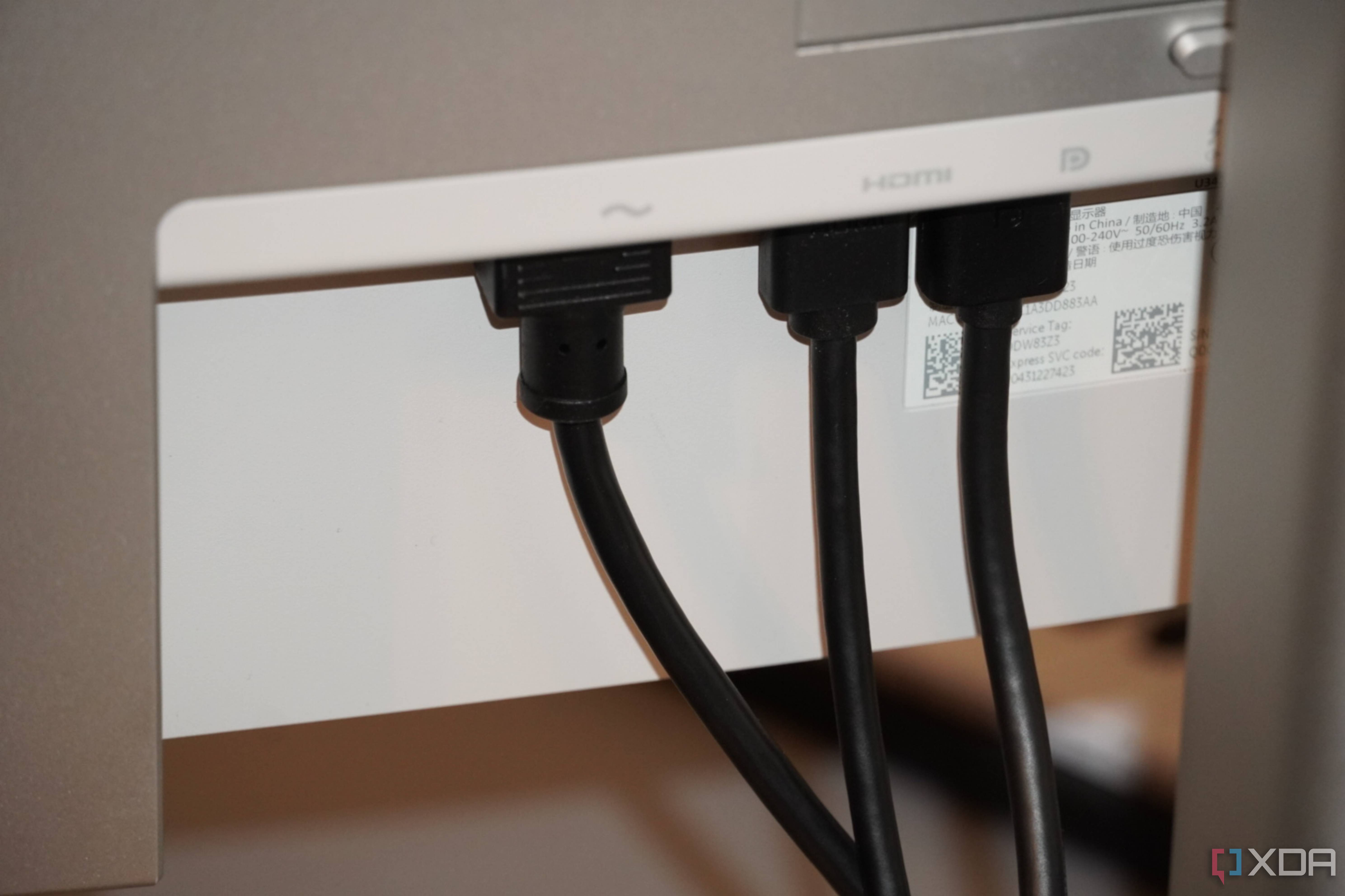 Video and power cables coming out of the UltraSharp 34 monitor.