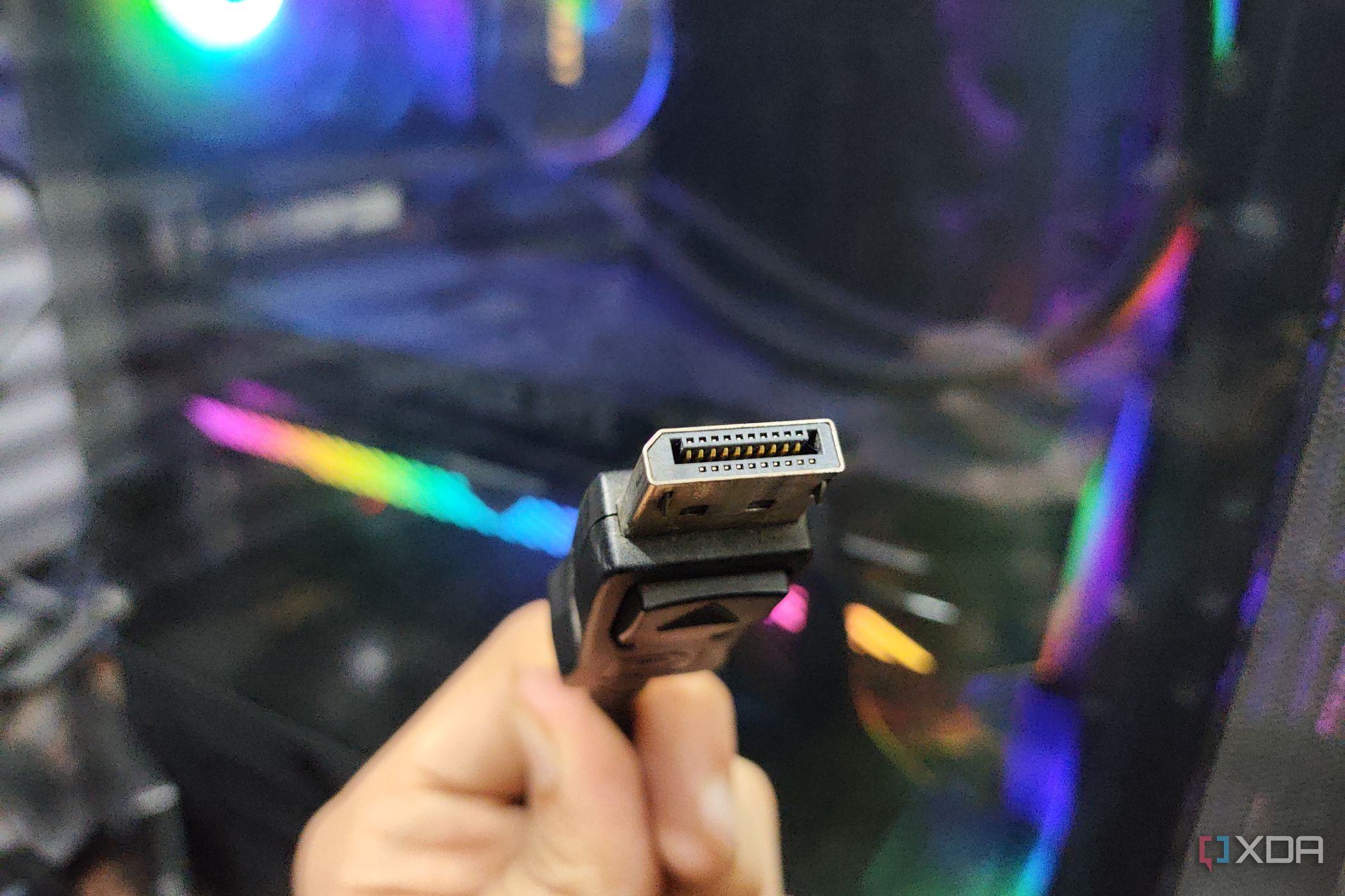 A DisplayPort cable held in front of a PC