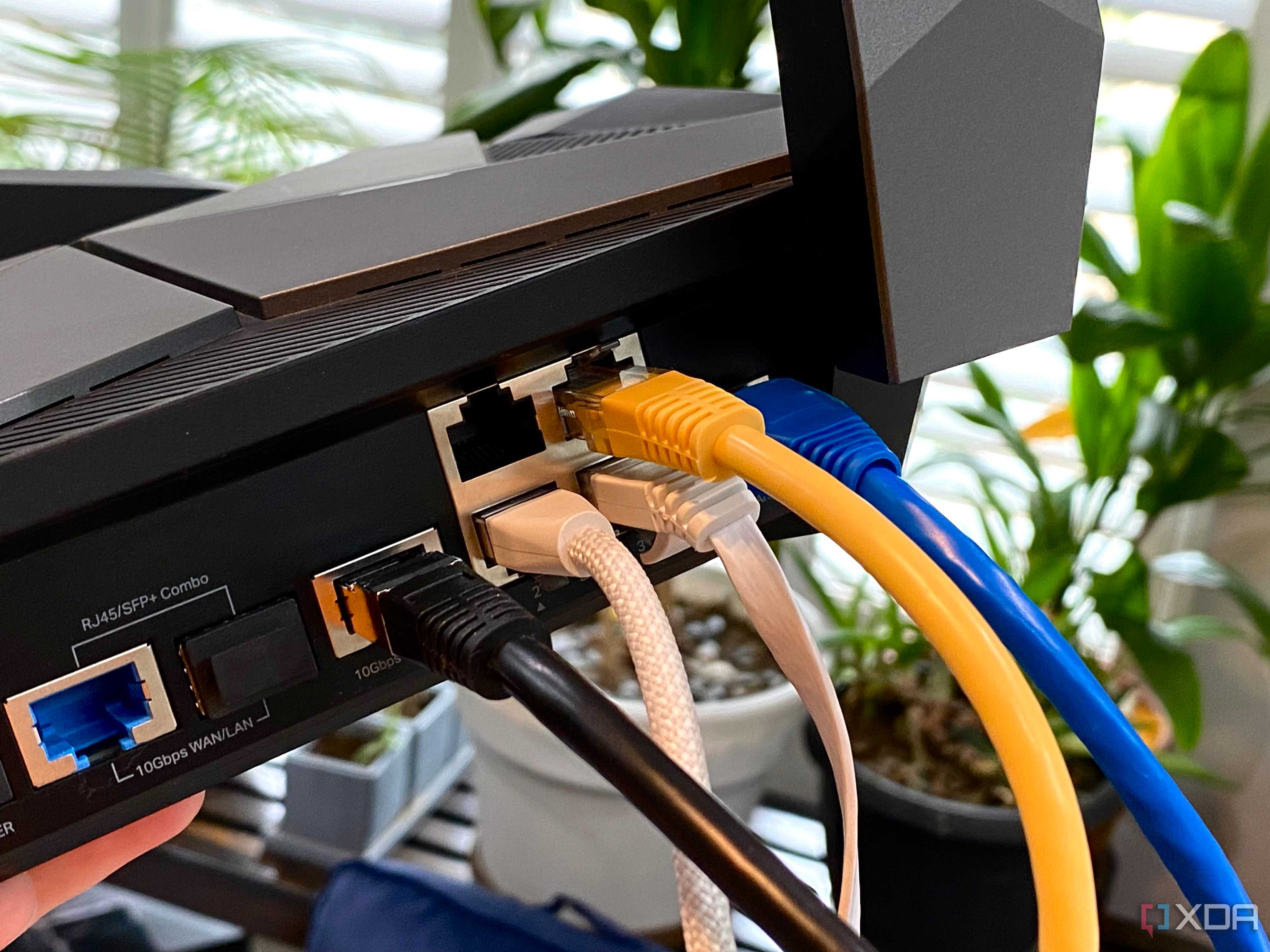 Ethernet cables of various types plugged into a TP-Link Archer AXE300