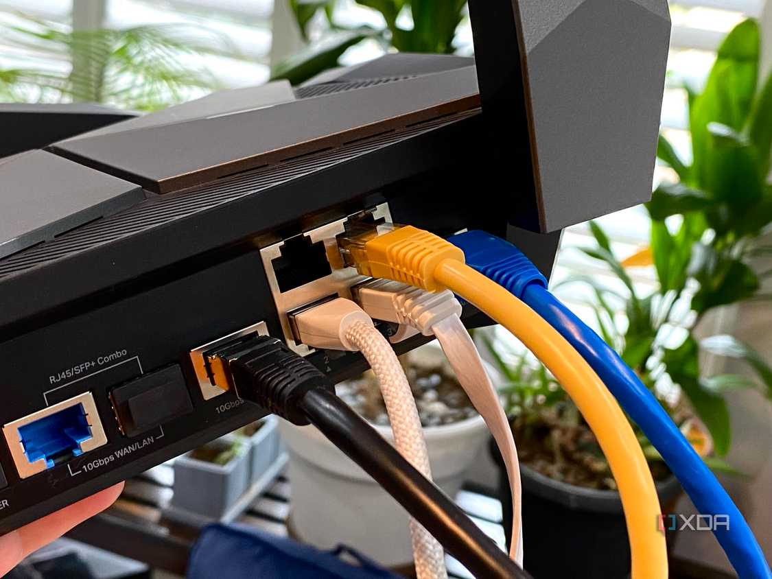 Ethernet cables of various types plugged into a TP-Link Archer AXE300