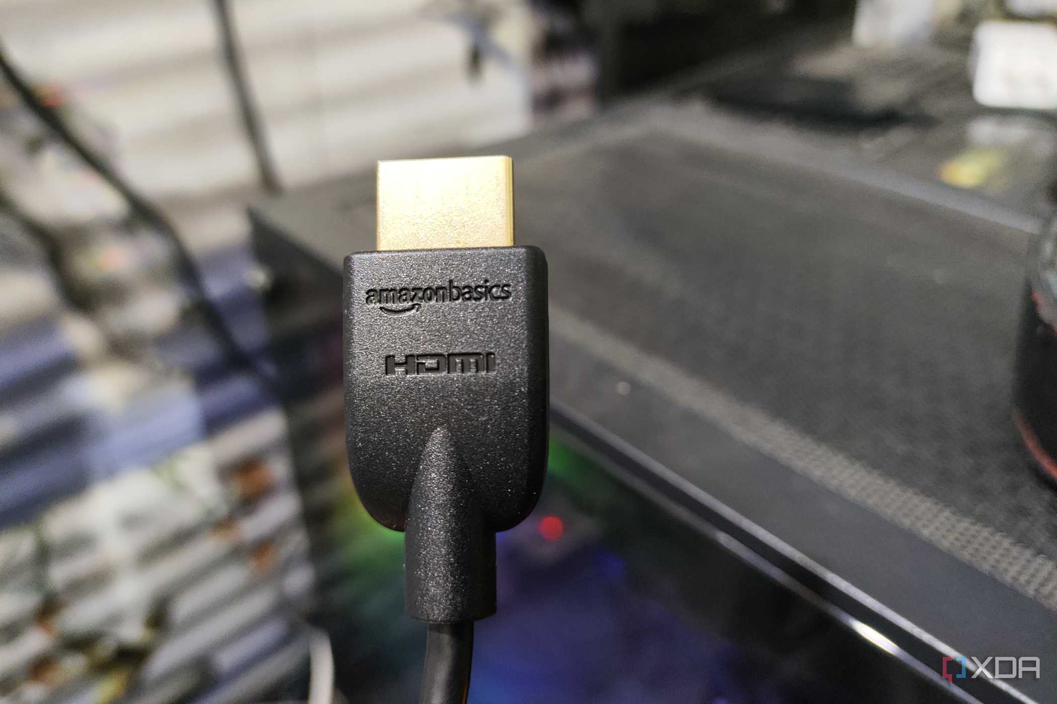 An HDMI cable held in front of a PC