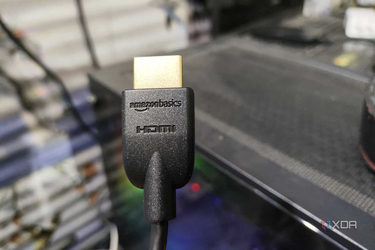 An HDMI cable held in front of a PC