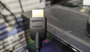 An HDMI cable held in front of a PC