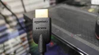 An HDMI cable held in front of a PC