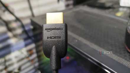 An HDMI cable held in front of a PC