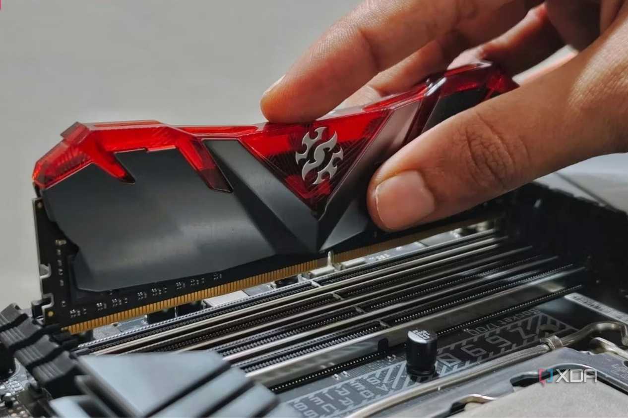 An image showing a person installing RAM modules on a motherboard.