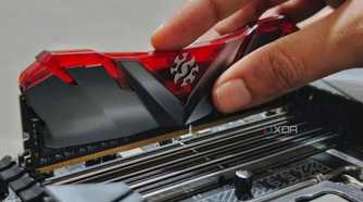 An image showing a person installing RAM modules on a motherboard.