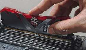 An image showing a person installing a ram module on the memory slot.