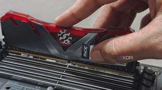 An image showing a person installing a ram module on the memory slot.