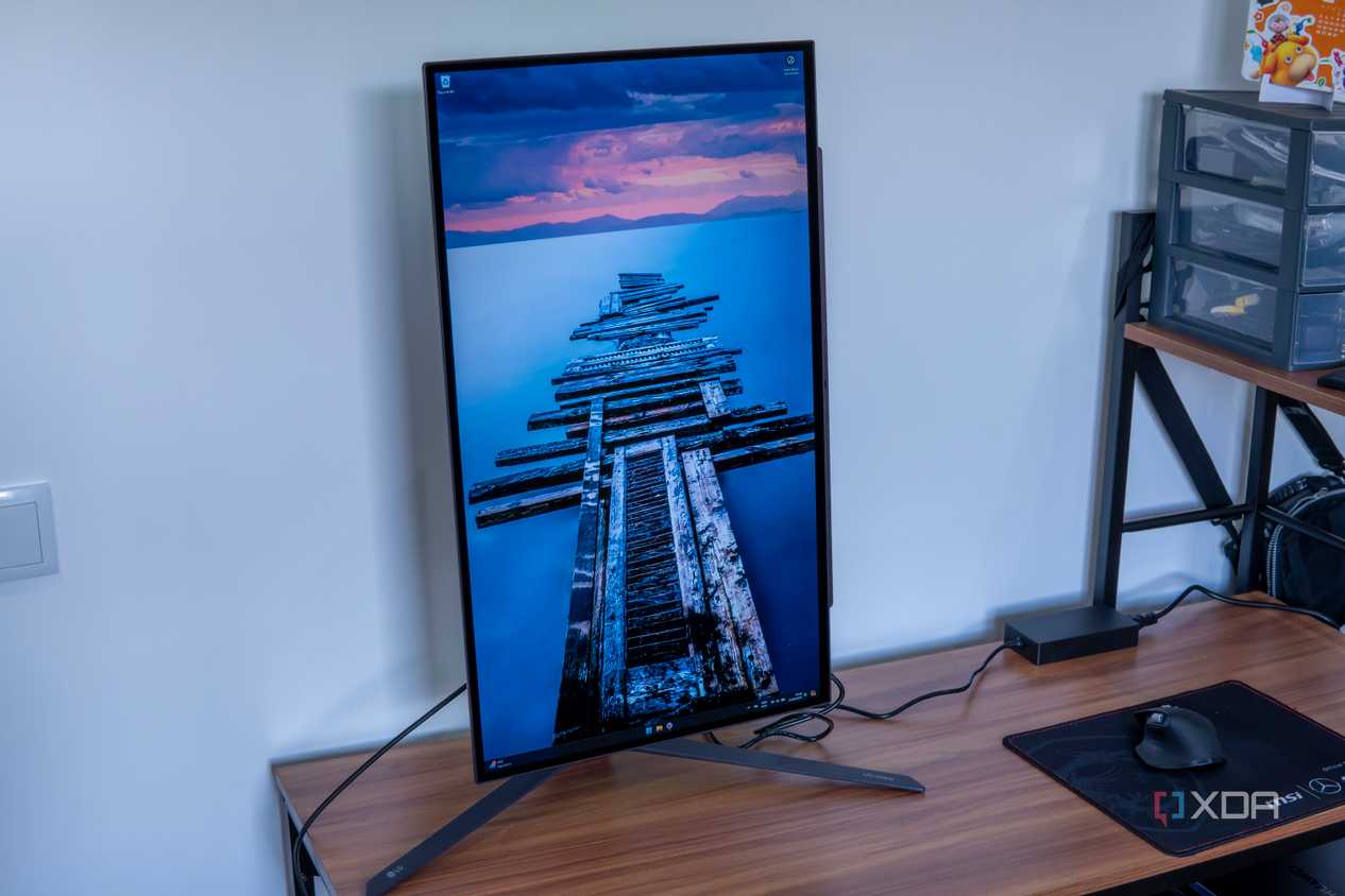 Angled front view of the LG UltraGear 27GR95QE with the screen in portrait orientation