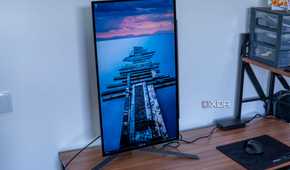 Angled front view of the LG UltraGear 27GR95QE with the screen in portrait orientation