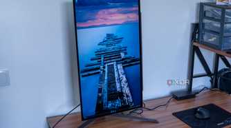 Angled front view of the LG UltraGear 27GR95QE with the screen in portrait orientation