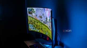 Angled view of the LG UltraGear 45GR95QE in a dark room playing Apex Legends with RGB lighting in the back