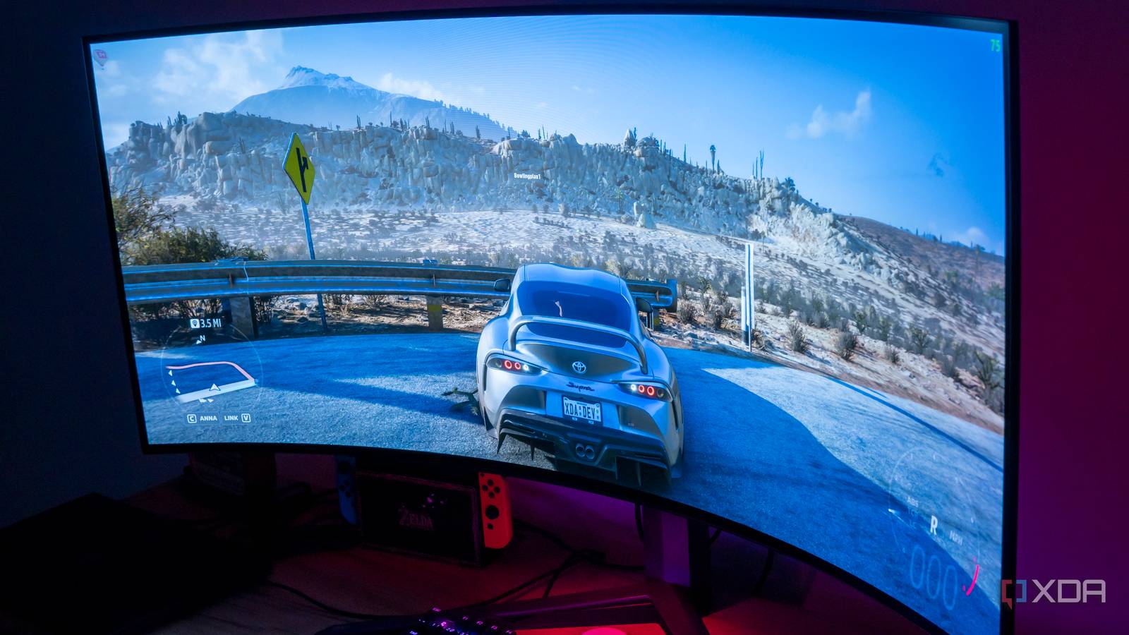 Angled view of the LG UltraGear 45GR95QE in a dark room with Forza Horizon 5 on the screen