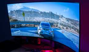 Angled view of the LG UltraGear 45GR95QE in a dark room with Forza Horizon 5 on the screen