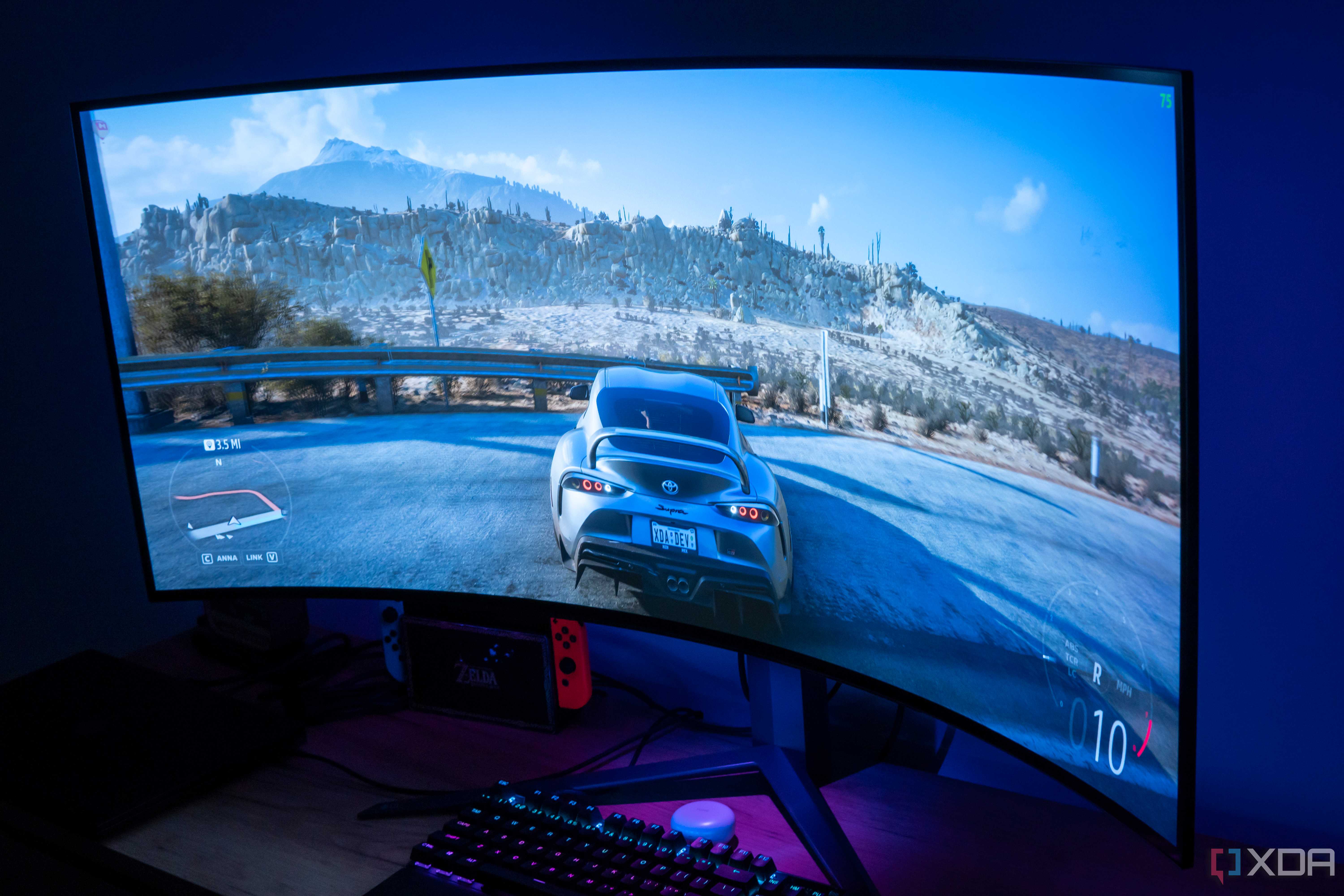 Angled view of the LG UltraGear 45GR95QE in a dark room with Forza Horizon 5 on the screen