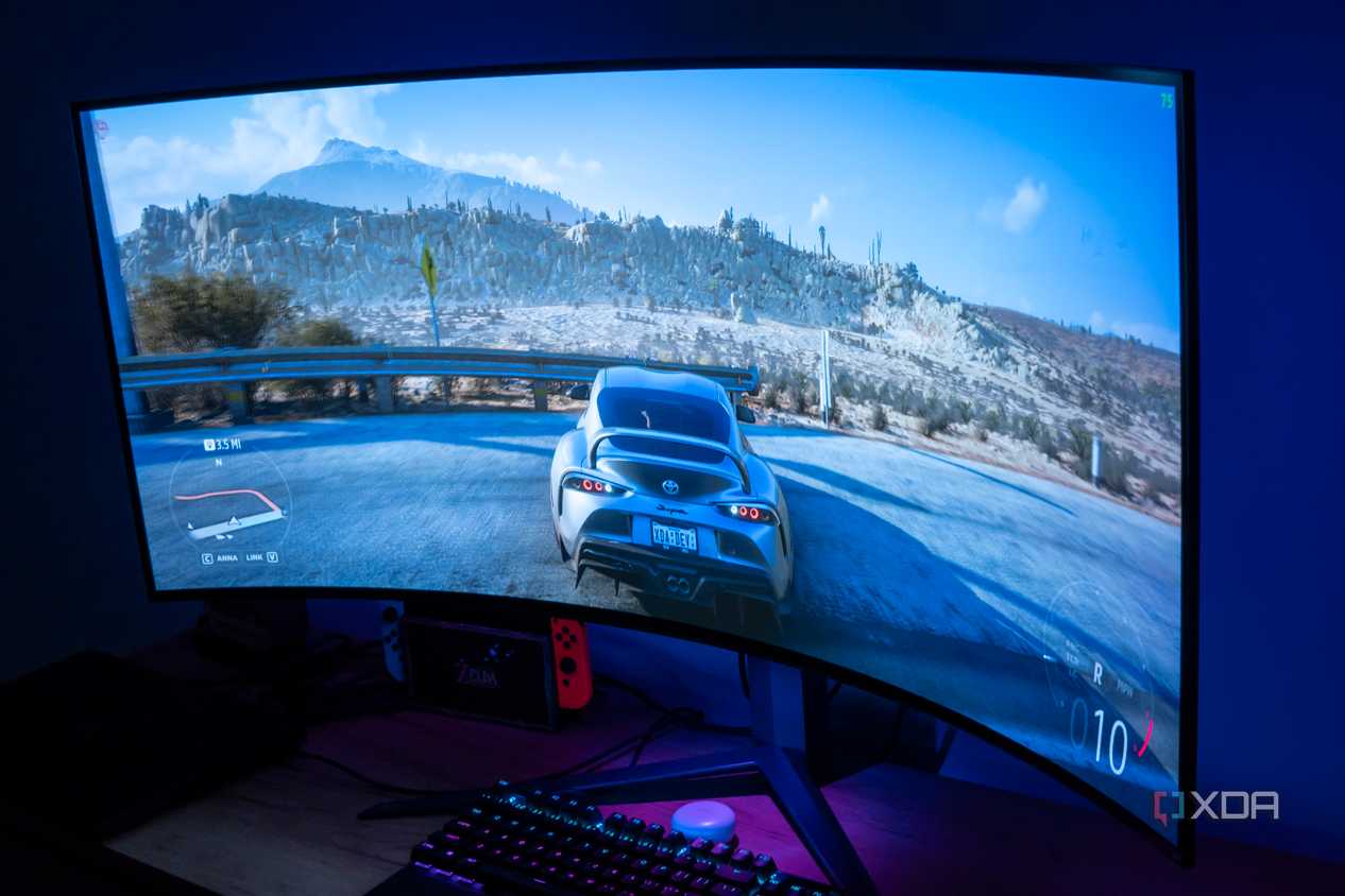 Angled view of the LG UltraGear 45GR95QE in a dark room with Forza Horizon 5 on the screen