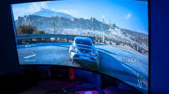 Angled view of the LG UltraGear 45GR95QE in a dark room with Forza Horizon 5 on the screen