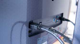 Close-up of the display inputs on the LG UltraGear 45GR95QE with HDMI and DisplayPort cables plugged in