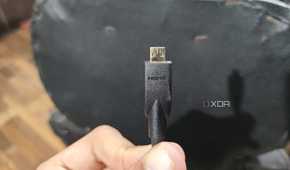 A person holding a micro-HDMI cable