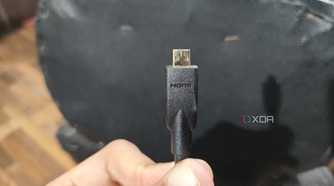 A person holding a micro-HDMI cable