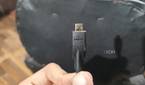 A person holding a micro-HDMI cable