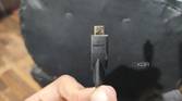 A person holding a micro-HDMI cable