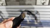A person holding a mini HDMI to HDMI adapter