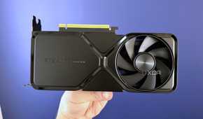 nvidia geforce rtx 4070 super founders edition held in front of blue wall