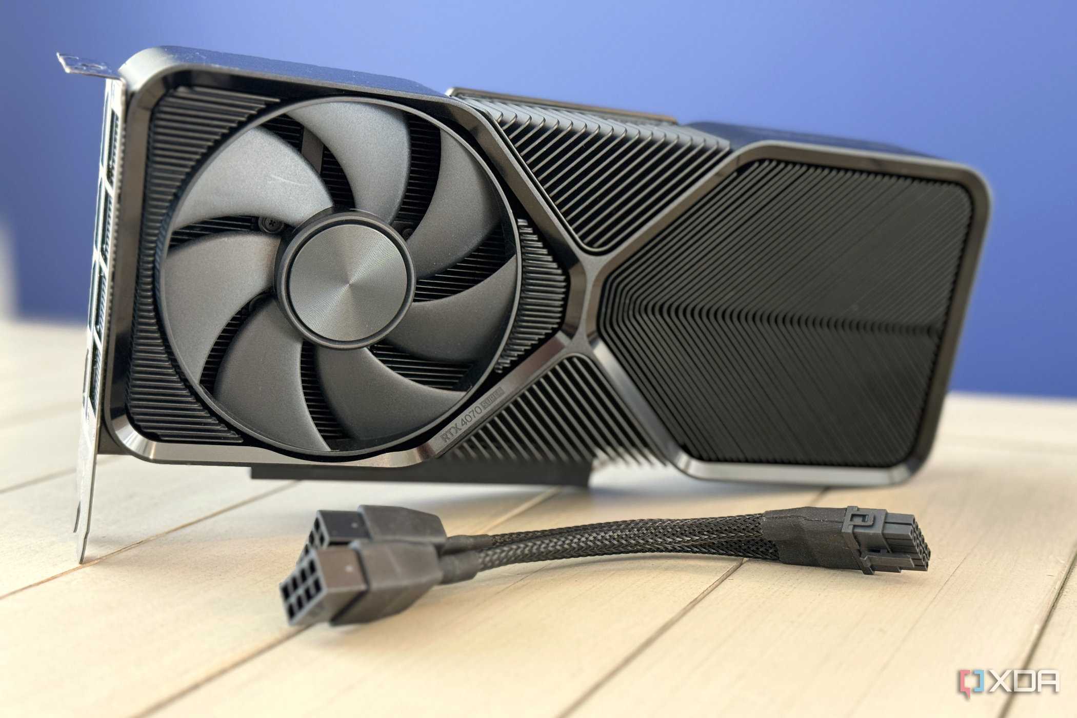 nvidia geforce rtx 4070 super founders edition stood up on table with pcie power adapter in front