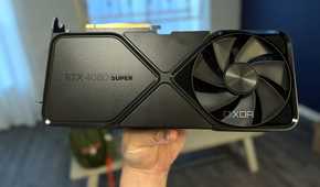 nvidia geforce rtx 4080 super fe held in hand in a dining room