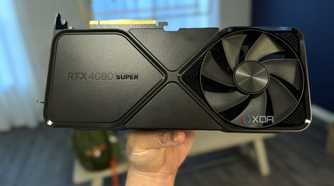 nvidia geforce rtx 4080 super fe held in hand in a dining room