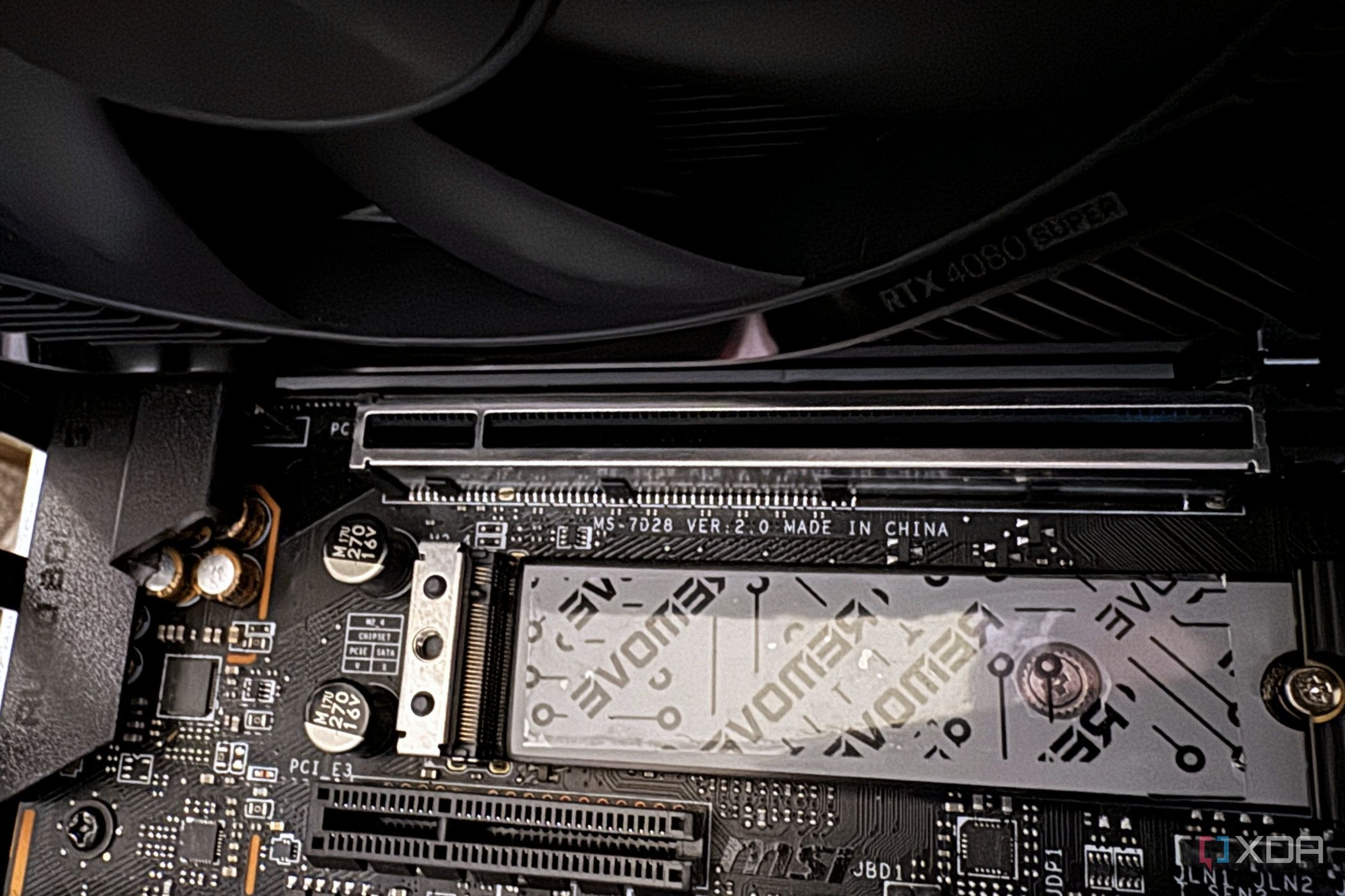 Underneath a nvidia geforce rtx 4080 super fe on the motherboard covering the pcie slots
