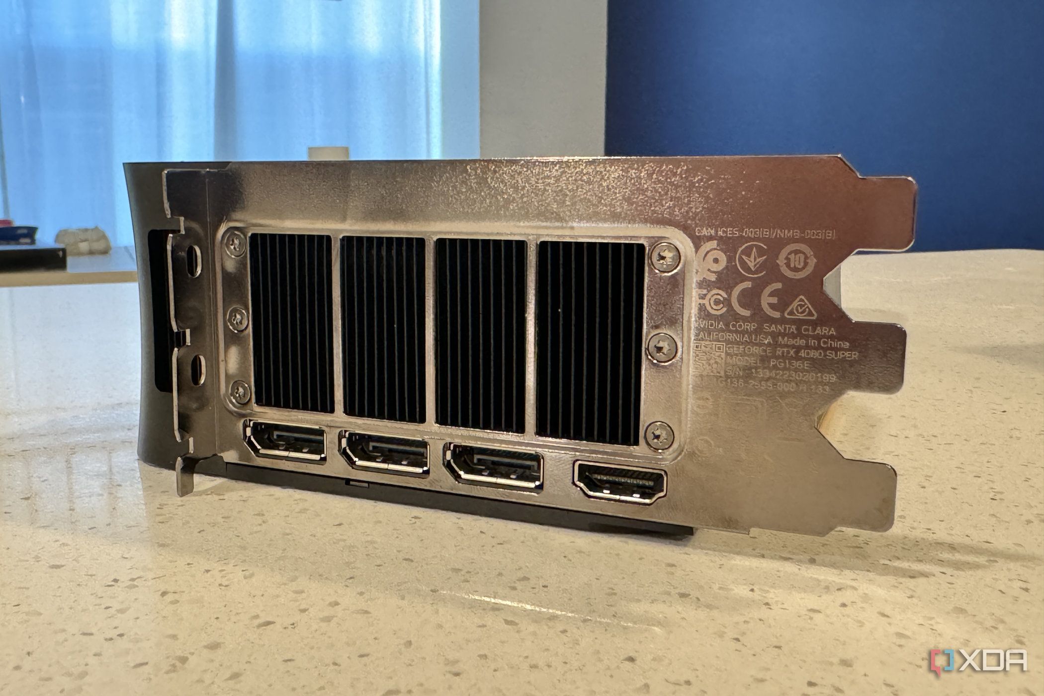 end view of the nvidia geforce rtx 4080 super fe io shield showing all four ports and the exhaust fan grille